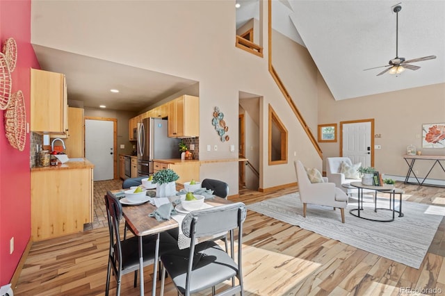 1345 Leslie Cir, Woodland Park, CO 80863 - dining space featuring light wood-type flooring, high vaulted ceiling, a ceiling fan, baseboard heating, and recessed lighting