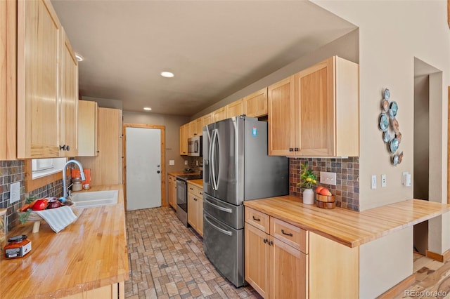 1345 Leslie Cir, Woodland Park, CO 80863 - kitchen with butcher block countertops, stainless steel appliances, light brown cabinets, decorative backsplash, and recessed lighting