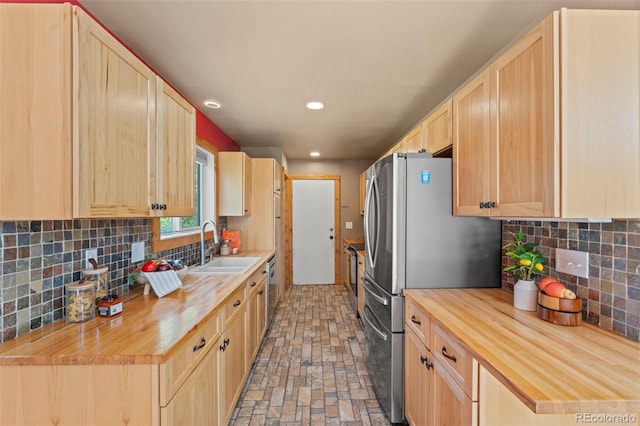 1345 Leslie Cir, Woodland Park, CO 80863 - kitchen with light brown cabinetry, butcher block countertops, stainless steel appliances, decorative backsplash, and recessed lighting