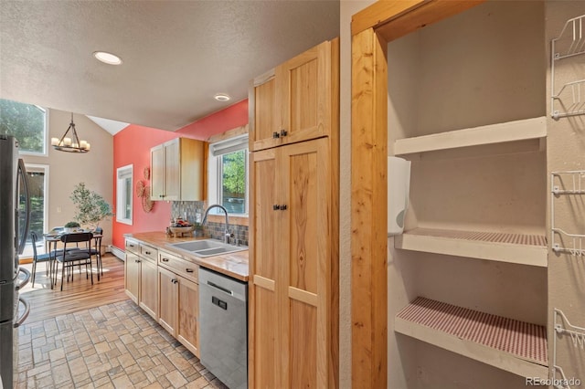 1345 Leslie Cir, Woodland Park, CO 80863 - kitchen with stainless steel appliances, a chandelier, a textured ceiling, light countertops, and tasteful backsplash