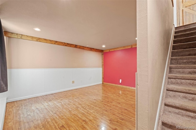 1345 Leslie Cir, Woodland Park, CO 80863 - stairs featuring wood finished floors, a wainscoted wall, and recessed lighting