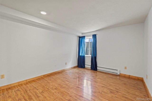 1345 Leslie Cir, Woodland Park, CO 80863 - spare room featuring a baseboard heating unit and wood finished floors