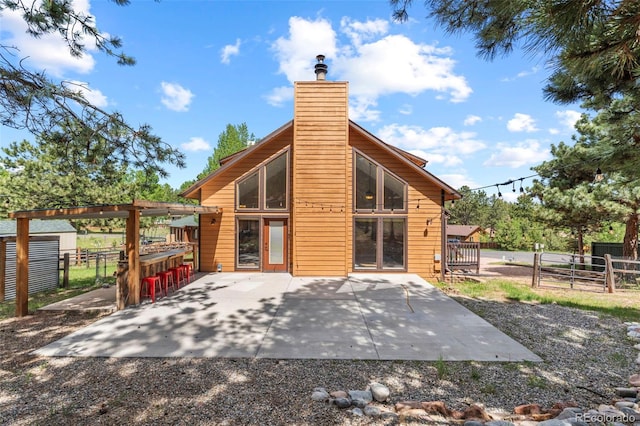 1345 Leslie Cir, Woodland Park, CO 80863 - rear view of house featuring a chimney and a patio