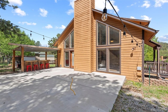 1345 Leslie Cir, Woodland Park, CO 80863 - rear view of property featuring a chimney and a patio area