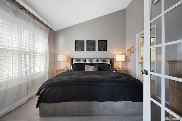 bedroom with carpet flooring and vaulted ceiling