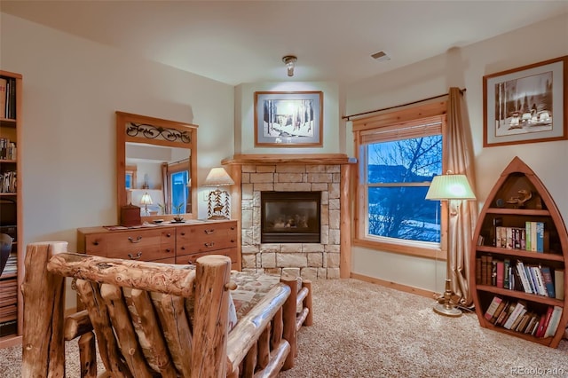 living area featuring a fireplace, carpet floors, and visible vents