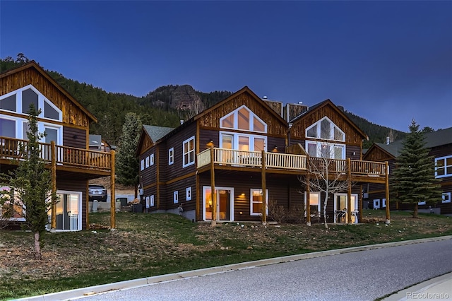 exterior space featuring a wooded view and a deck