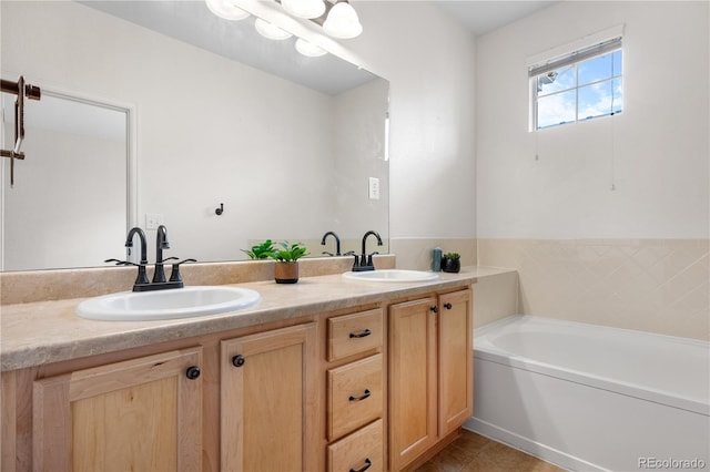 bathroom with tile patterned flooring, vanity, and a tub to relax in