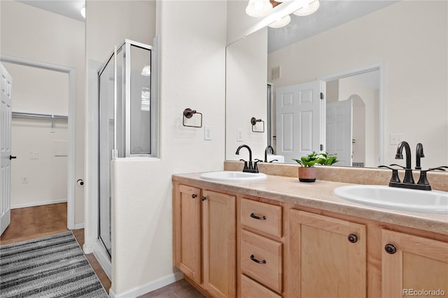 bathroom with an enclosed shower and vanity