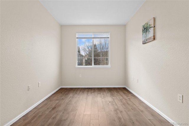 empty room with light hardwood / wood-style floors