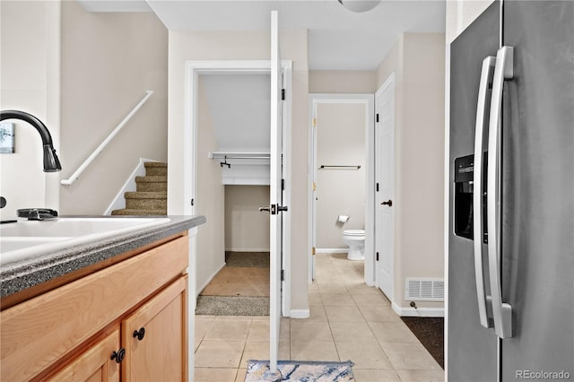 bathroom featuring vanity, toilet, and tile patterned flooring