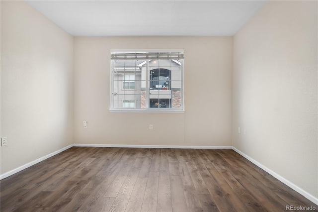 unfurnished room featuring dark hardwood / wood-style flooring