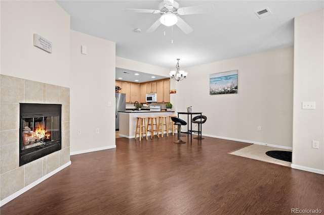 15945 E Geddes Dr Unit 54, Aurora, CO 80016 - living area featuring dark wood-type flooring, a chandelier, a ceiling fan, recessed lighting, and a tile fireplace