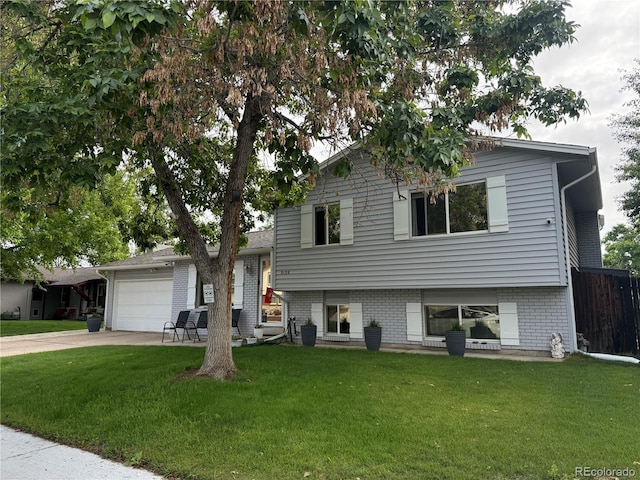 7132 Xavier Way, Westminster, CO 80030 - split level home featuring an attached garage, concrete driveway, and brick siding