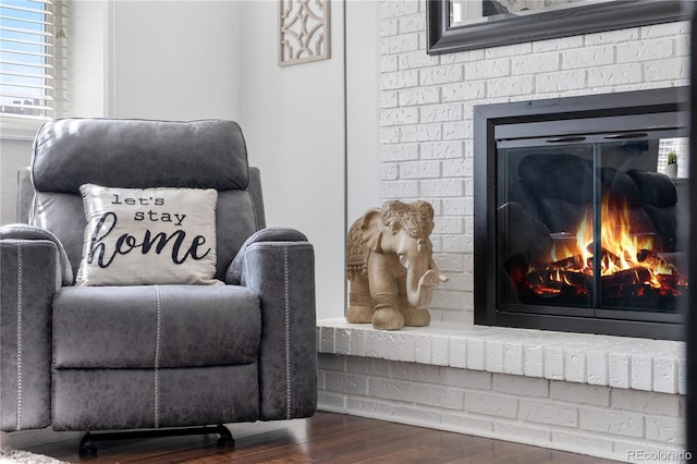 7132 Xavier Way, Westminster, CO 80030 - sitting room with a brick fireplace and wood finished floors