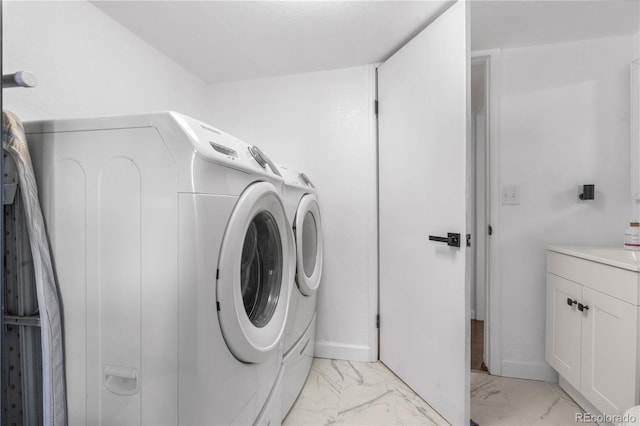 7132 Xavier Way, Westminster, CO 80030 - laundry area featuring washer and dryer, light marble finish floors, and cabinet space