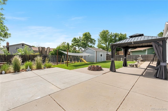 7132 Xavier Way, Westminster, CO 80030 - fenced backyard with a patio, a playground, a fire pit, a gazebo, and a storage unit