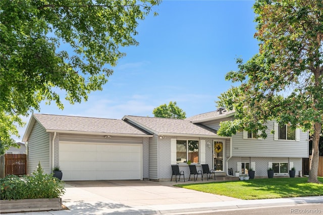 7132 Xavier Way, Westminster, CO 80030 - tri-level home with a garage, concrete driveway, and brick siding