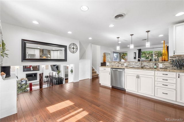 7132 Xavier Way, Westminster, CO 80030 - kitchen with dishwasher, a peninsula, tasteful backsplash, white cabinets, and light stone countertops