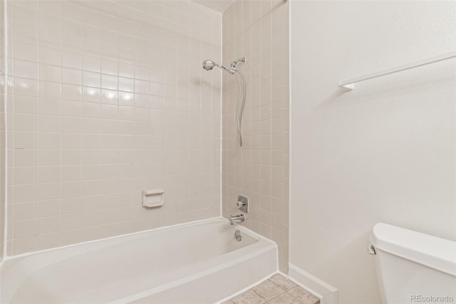 full bath featuring toilet, bathing tub / shower combination, tile patterned flooring, and baseboards