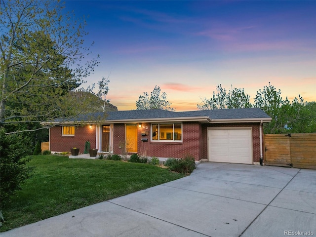 207 Iowa Dr, Golden, CO 80403 - ranch-style house featuring concrete driveway, a garage, and brick siding