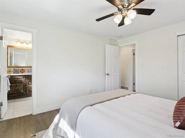 207 Iowa Dr, Golden, CO 80403 - bedroom with wood finished floors, baseboards, connected bathroom, a closet, and ceiling fan