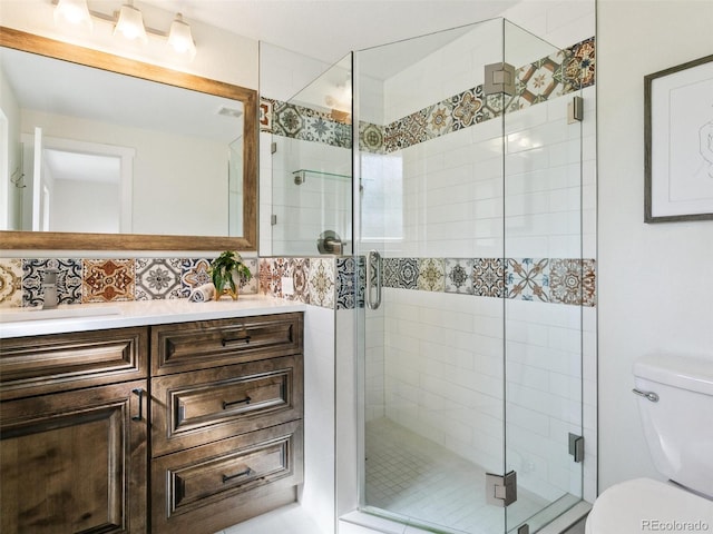 207 Iowa Dr, Golden, CO 80403 - bathroom with toilet, vanity, a shower stall, and backsplash