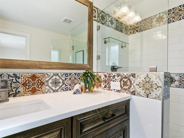 207 Iowa Dr, Golden, CO 80403 - bathroom with a tile shower, vanity, and tasteful backsplash