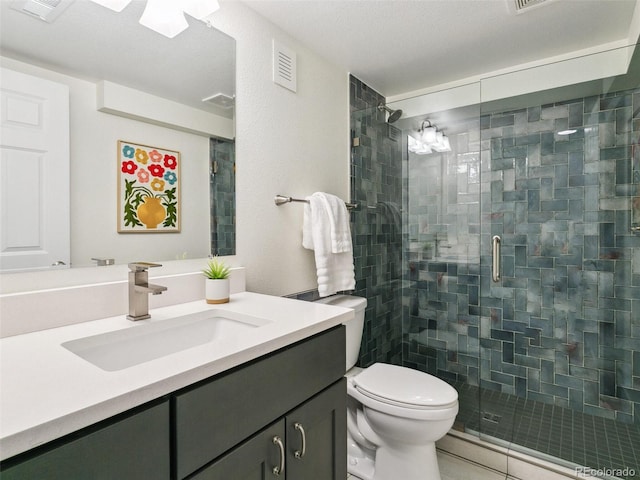 207 Iowa Dr, Golden, CO 80403 - full bathroom featuring a stall shower, toilet, and vanity