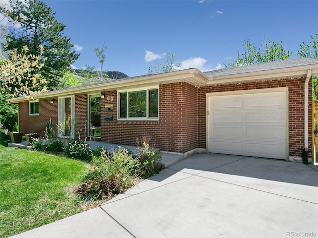 207 Iowa Dr, Golden, CO 80403 - ranch-style house with a garage, brick siding, concrete driveway, and a front lawn