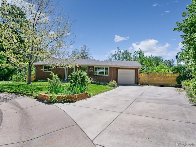 207 Iowa Dr, Golden, CO 80403 - single story home featuring a garage, concrete driveway, and brick siding