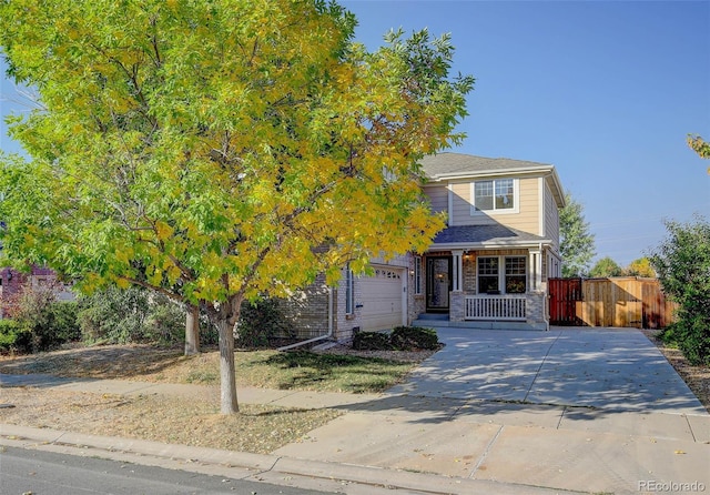 obstructed view of property with covered porch and a garage