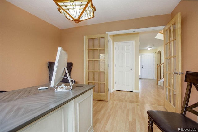 office space featuring french doors and light hardwood / wood-style floors