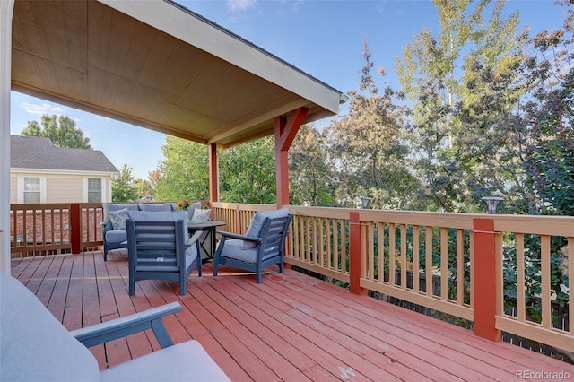 wooden terrace with an outdoor hangout area