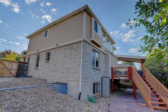 rear view of house featuring a wooden deck