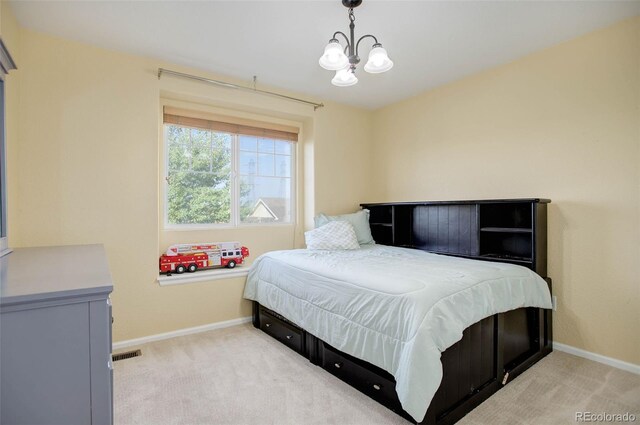 bedroom with light carpet and a notable chandelier