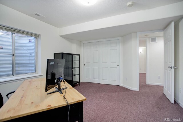 office with carpet flooring and a textured ceiling