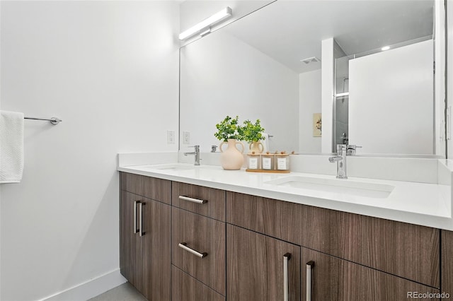 4394 Zenobia St, Denver, CO 80212 - bathroom featuring double vanity and baseboards