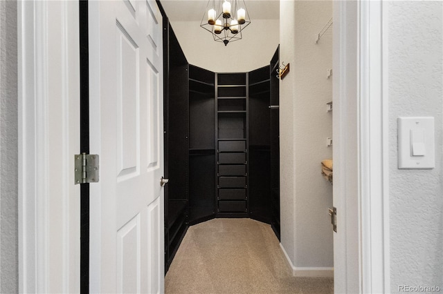 walk in closet featuring an inviting chandelier