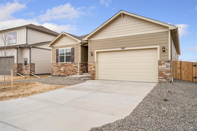 874 Ledge St, Lochbuie, CO 80603 - view of front of house with stone siding, driveway, and an attached garage