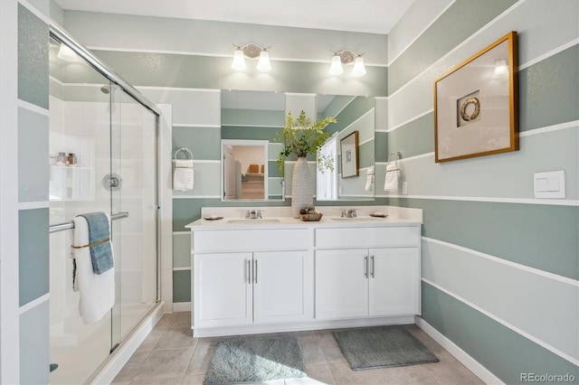 874 Ledge St, Lochbuie, CO 80603 - bathroom featuring a stall shower, double vanity, and tile patterned floors
