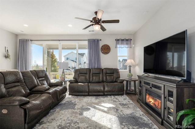 living room featuring dark hardwood / wood-style floors and ceiling fan