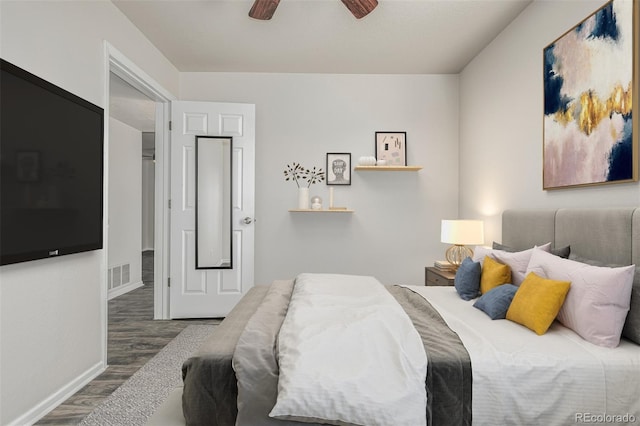 bedroom with dark wood-style floors, baseboards, visible vents, and a ceiling fan