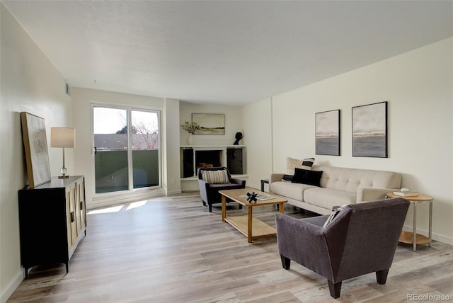 living room with light wood finished floors and baseboards