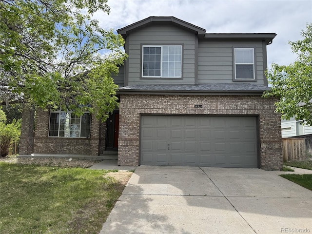 4338 N Ceylon Ct, Denver, CO 80249 - traditional home featuring brick siding, an attached garage, concrete driveway, and a front lawn