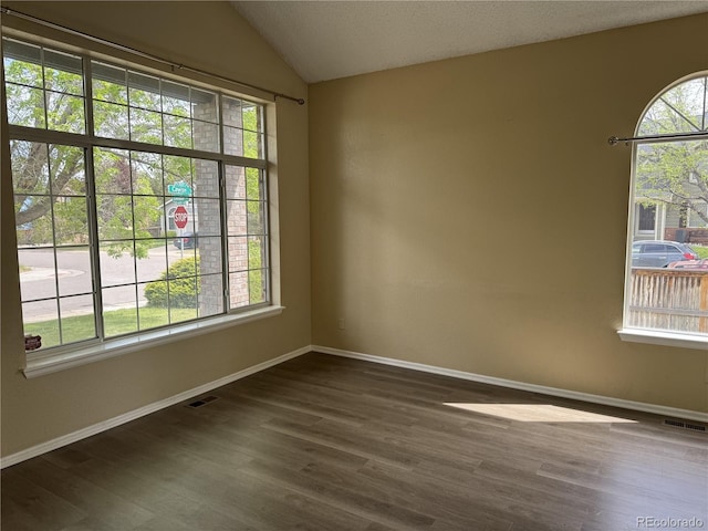 4338 N Ceylon Ct, Denver, CO 80249 - unfurnished room featuring dark wood-style flooring, baseboards, and vaulted ceiling