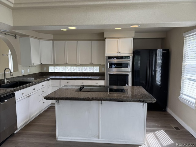 4338 N Ceylon Ct, Denver, CO 80249 - kitchen with black appliances, a sink, white cabinets, dark wood-style floors, and recessed lighting