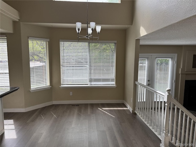 4338 N Ceylon Ct, Denver, CO 80249 - unfurnished dining area with wood finished floors, a chandelier, and baseboards
