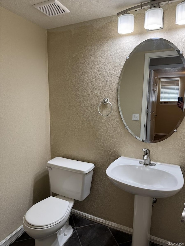 4338 N Ceylon Ct, Denver, CO 80249 - half bathroom with toilet and tile patterned flooring
