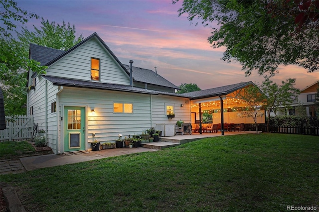 6830 Lamar St, Arvada, CO 80003 - back of property at dusk with a patio